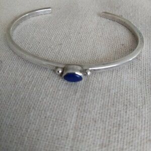 V. Hicks: Sterling open cuff bracelet with center blue stone.